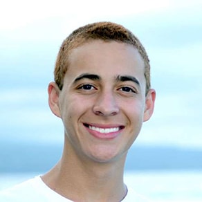 A young man smiles to show how Invisalign from this dentist in Columbia, SC, straightens your smile without traditional braces.